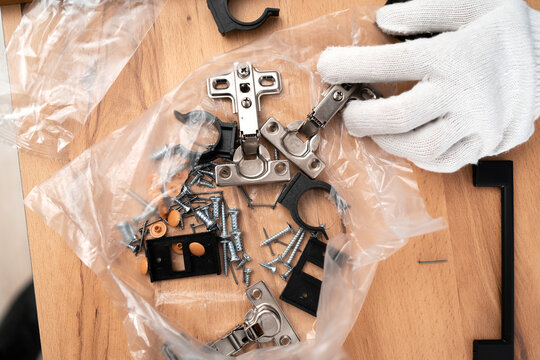 furniture door hinges on the table. concept of furniture assembly