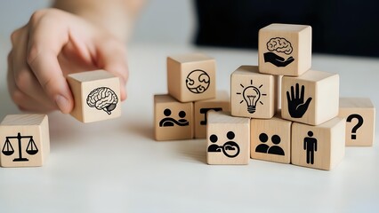 Hand arranging wooden blocks with business icons including brain, lightbulb, people, and question mark for strategic planning and decision making.