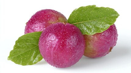 Fresh plums resting on a clean surface with glistening droplets in bright light