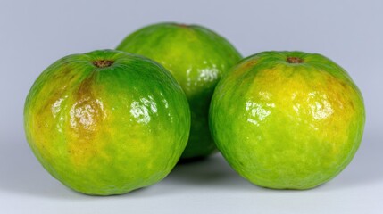 Fresh green limes with a vibrant sheen showcasing their natural beauty and texture