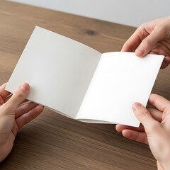 Obraz premium Person holding an open blank book on a wooden table