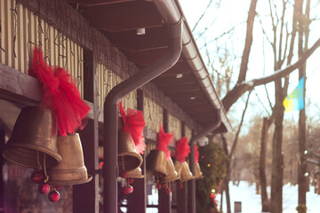 Christmas Bells with Red Ribbons Hanging Outdoors, Festive Decor