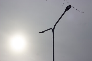 Street Lamp Against Foggy Sky with Sun, Minimal Urban Scene