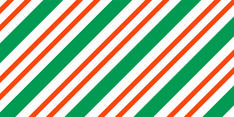 Christmas seamless pattern. Red and green diagonal stripes background. Candy cane repeating decoration wallpaper. Winter holiday lines backdrop. vector