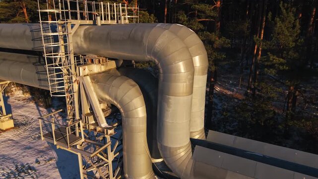 Close view of insulated pipe bend with scaffolding and textured surface highlights for technical visuals
