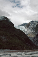 Close View of Fox Glacier Ice Between Dark Mountain Slopes, New Zealand