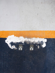 Painted blue, yellow and white walls with stain, cracked and some bracket mounted.