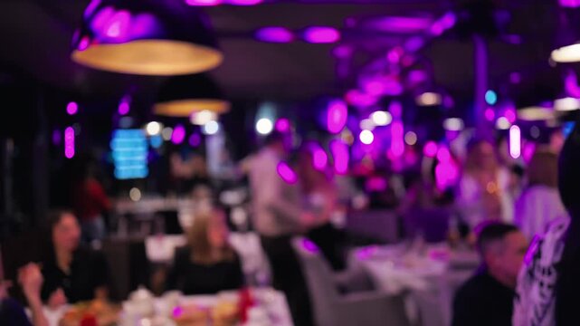 Live performance with vibrant lighting, Musical event illuminated by purple spotlight and cheering fans
