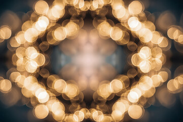 Symmetrical pattern of blurred warm golden lights creating an abstract bokeh effect with a glowing center and soft ambient atmosphere on a dark background