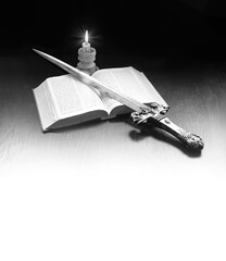 Old book and sword on the table