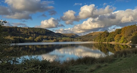 serene lake landscape with rolling hills and dramatic cloud reflections in autumn light
