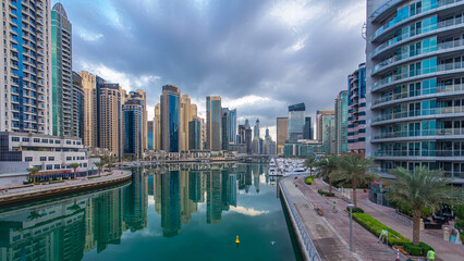 Naklejka premium Dubai Marina towers and canal in Dubai night to day timelapse