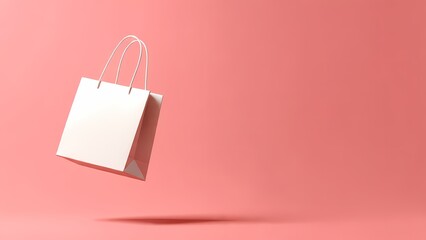 A white paper shopping bag floating against a solid coral pink background perfect for retail marketing and sales promotion graphics.