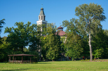 Church of Saints Cyril and Methodius (kości&oacute;ł Świętych Cyryla i Metodego) behind trees. Knur&oacute;w, Poland.
