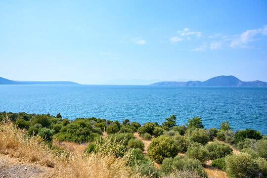 Serene coastal landscape with clear blue Lake Bafa and lush greenery
