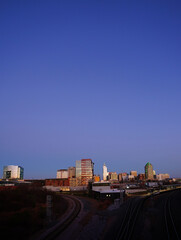 The downtown Raleigh skyline and railroad tracks at sunset