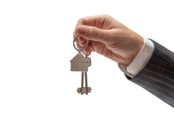 Concept of selling or renting a car. Hand of man in formal suit holding car keys on isolated background