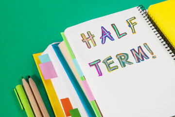 School Holidays concept. Fun colorful inscriptions in a children's style. Notepads, notebooks, textbooks, school stationery