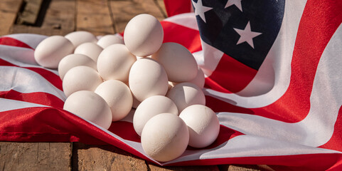 Chicken eggs with the US flag in the background. Countryside outdoor setting