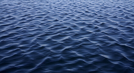 A mesmerizing shot of deep blue ocean waves creating a tranquil and serene ripple pattern. Perfect as a nature background, capturing the essence of the sea with its rhythmic flow.