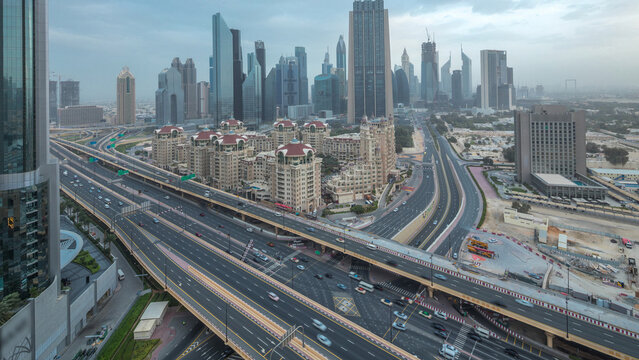 Dubai downtown skyline night to day aerial timelapse with traffic on highway