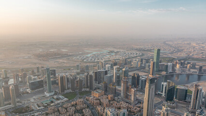 Fototapeta premium Downtown of Dubai night to day timelapse before sunrise. Aerial view with towers and skyscrapers
