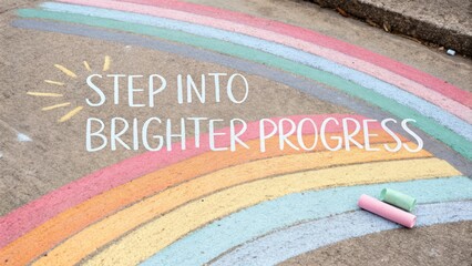 Colorful rainbow chalk artwork on a sidewalk with inspiring text