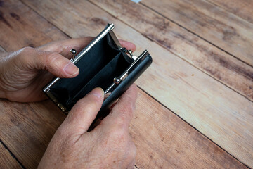 Empty Wallet Held by Elderly Hands