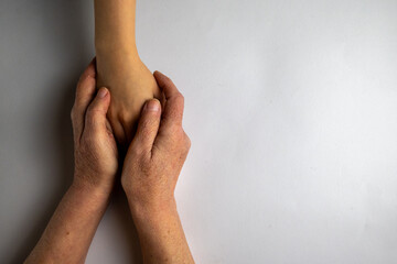 Elderly Hands Protecting Young Arm