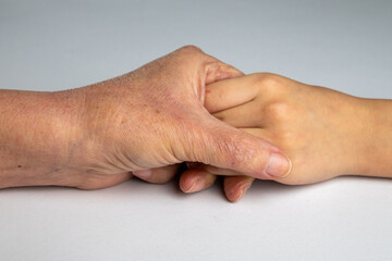 Young Hand Supporting Elderly Hand