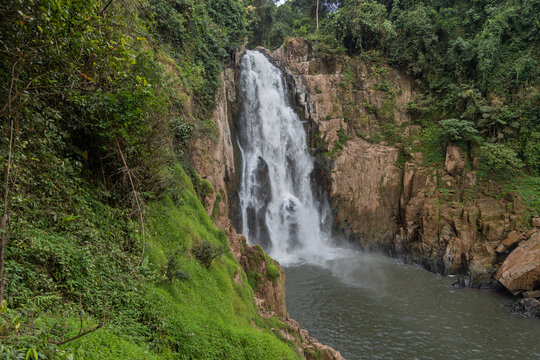 powerful 60-metre haew narok waterfall cascading in dense jungle, khao yai national park, thailand