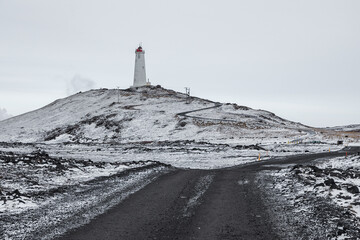 Lighthouse in winter landscape on Reykjanes Peninsula, Iceland.