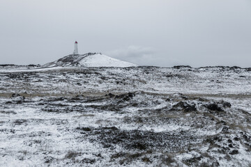 Lighthouse in winter landscape on Reykjanes Peninsula, Iceland.