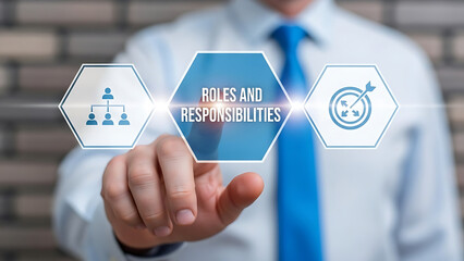 Businessman pointing to roles and responsibilities icons on a transparent screen