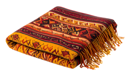 A folded blanket with a vibrant woven pattern and long fringe against a black backdrop