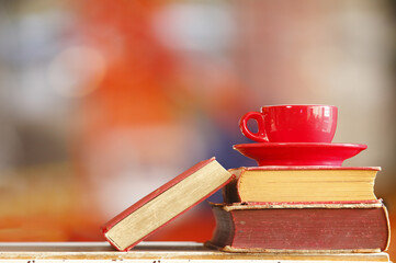 Stack of books with coffee cup,reading,learning,education, literature concept.Blurred background.