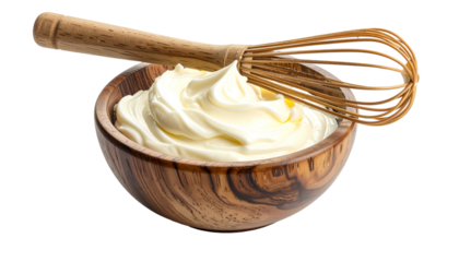 Creamy, whipped dairy product in a wooden bowl with a whisk resting on the edge