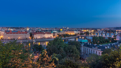 Fototapeta premium Evening Panorama of Prague with Vltava river and Prague Bridges day to night timelapse.