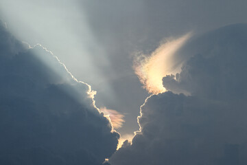 The natural phenomenon of light refraction between rain clouds occurs during the day.