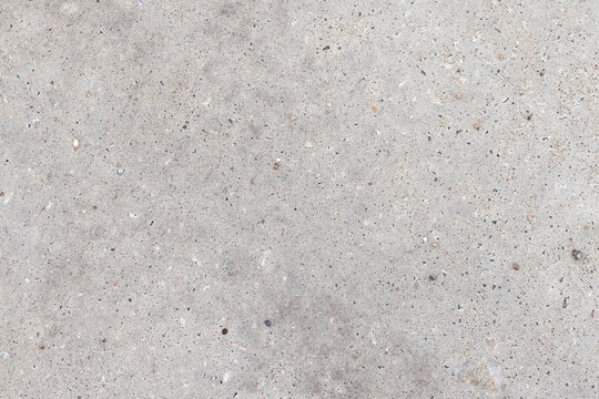 A close-up of a gray concrete pavement texture, background photo
