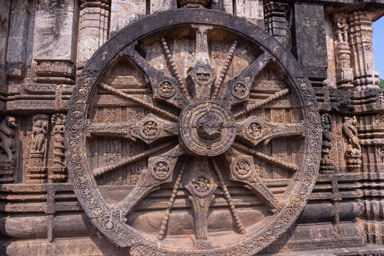 Architectural exterior view of ancient konark sun temple building built in 13th century. One of the twenty four carved giant stone wheels at Konark temple on single piece of stone.