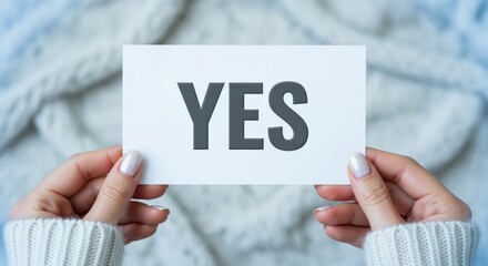 Affirmative answer: Woman holding card with word YES, positive confirmation and acceptance on soft background