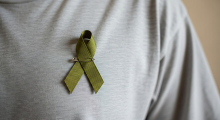 Green Awareness Ribbon on Gray Shirt Pinned for Support