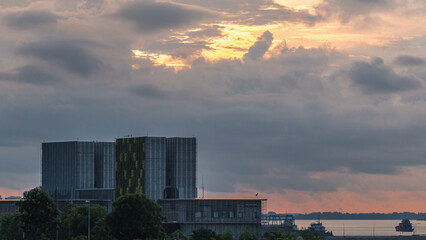 Beautiful sunrise at Marina Barrage timelapse. Orange sky and clouds with sun beams.