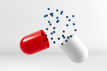 Open red and white capsule releasing glossy blue spherical particles - 3D render