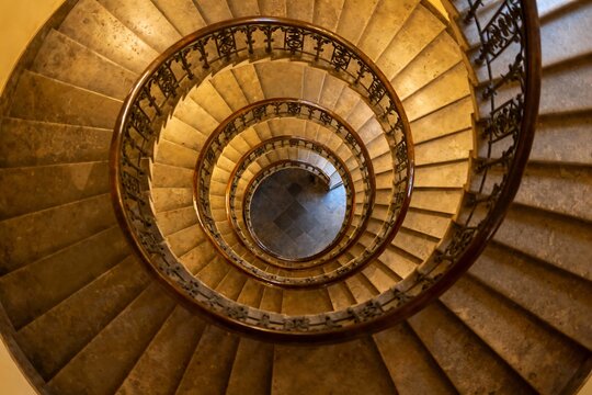 Generative AI a detailed view of an ornate spiral staircase capturing intricate ironwork and warm - Powered by Adobe