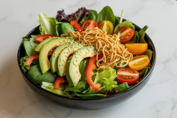 Fresh mixed green salad with avocado tomatoes and crispy noodles mixed greens cherry tomato