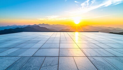 Large tiled platform overlooking mountain range bathed in the golden light of a sunrise