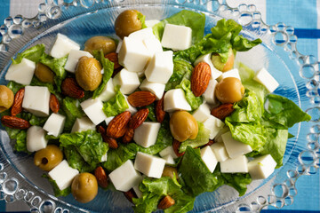 Gourmet keto friendly salad with olives almonds and white cheese