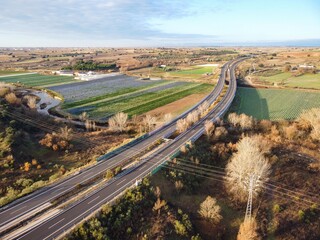 View of a rural landscape with a highway and fields during daylight in an open area